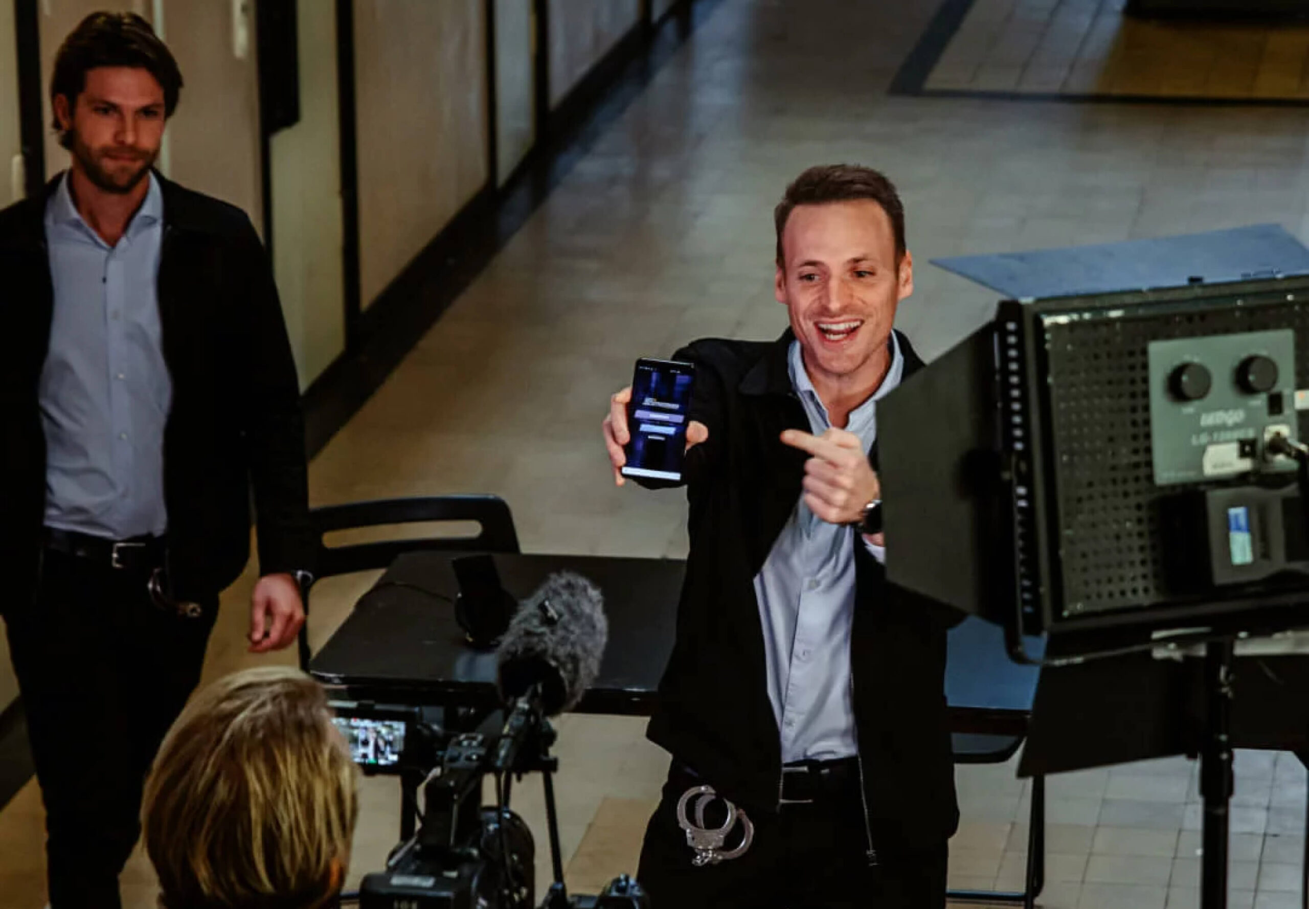 A producer? from Talpa showing something on his phone to a colleague